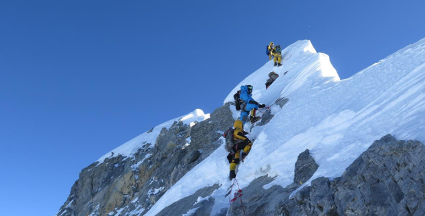 Alpinisti in arrampicata su una vetta innevata